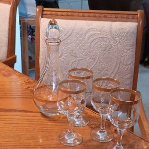 Gold leaf wine decanter and 4 wine glasses.